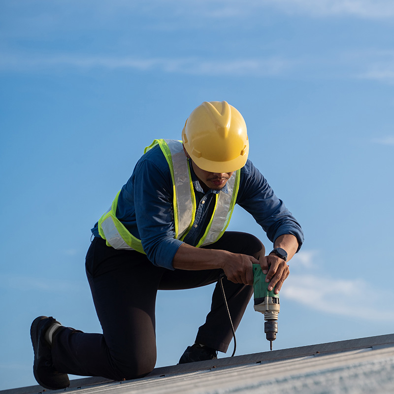 Worker repairing the roof on a construction site